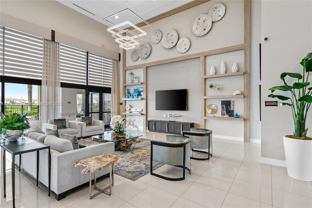 10468 W 33rd Ln, Hialeah, FL 33018 - living room featuring a high ceiling, tile patterned flooring, and a chandelier