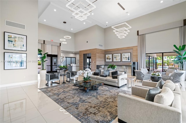 10468 W 33rd Ln, Hialeah, FL 33018 - tiled living room with a towering ceiling, a chandelier, and recessed lighting