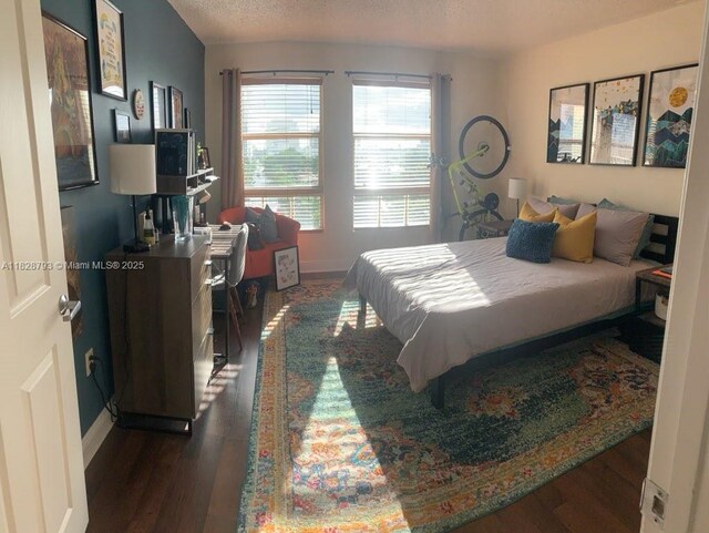 2351 Douglas Rd Unit 505, Miami, FL 33145 - bedroom featuring dark wood-style flooring and baseboards