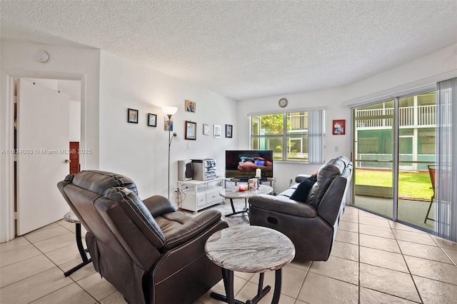 2657 SE 19th Ct Unit 103-E, Homestead, FL 33035 - living room with light tile patterned flooring and a textured ceiling