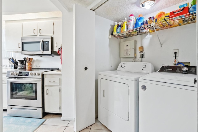 2657 SE 19th Ct Unit 103-E, Homestead, FL 33035 - laundry area featuring separate washer and dryer, light tile patterned flooring, and a textured ceiling