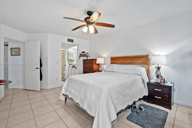 2657 SE 19th Ct Unit 103-E, Homestead, FL 33035 - bedroom with light tile patterned flooring, a textured ceiling, a ceiling fan, and ensuite bath