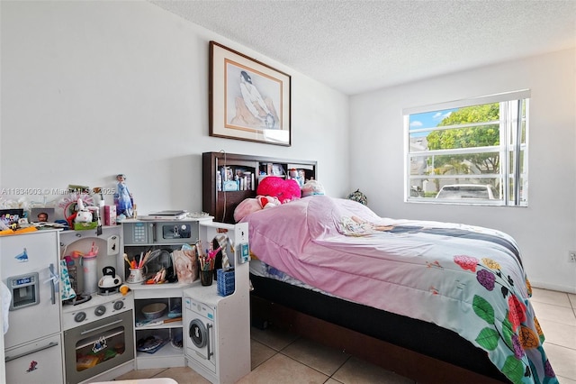 2657 SE 19th Ct Unit 103-E, Homestead, FL 33035 - bedroom featuring light tile patterned floors and a textured ceiling