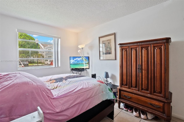 2657 SE 19th Ct Unit 103-E, Homestead, FL 33035 - bedroom with a textured ceiling and light tile patterned floors