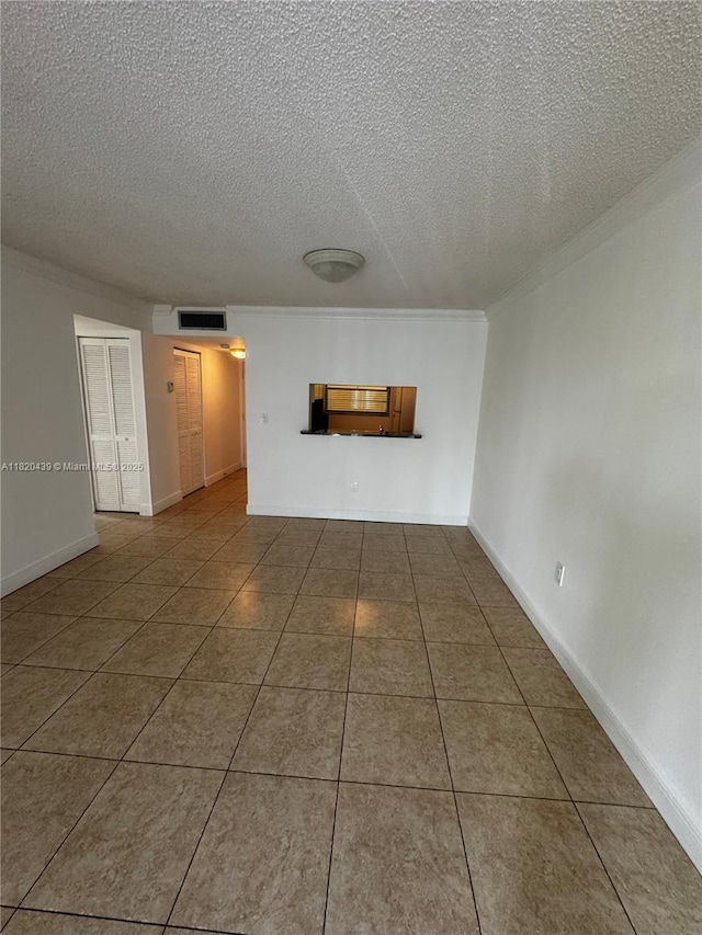 10875 SW 112th Ave Unit 206, Miami, FL 33176 - tiled empty room with a textured ceiling and ornamental molding
