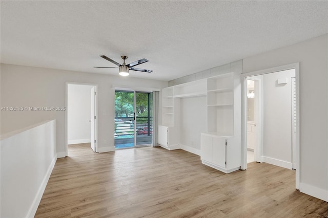 303 Gardens Dr Unit 203, Pompano Beach, FL 33069 - spare room with ceiling fan, light wood-type flooring, and a textured ceiling