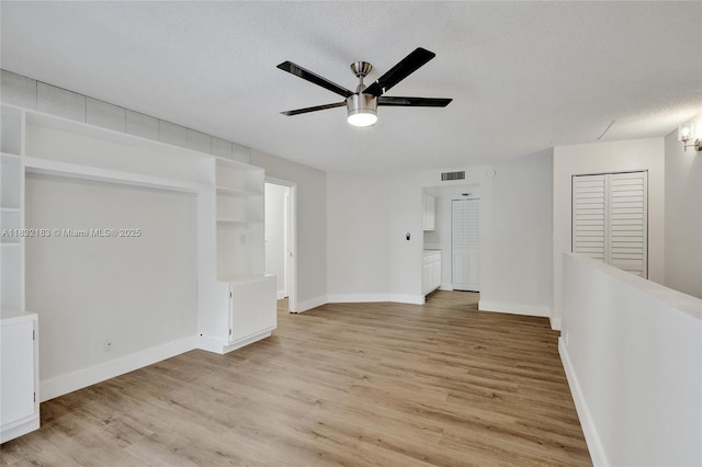 303 Gardens Dr Unit 203, Pompano Beach, FL 33069 - unfurnished room with ceiling fan, light wood-style floors, and a textured ceiling