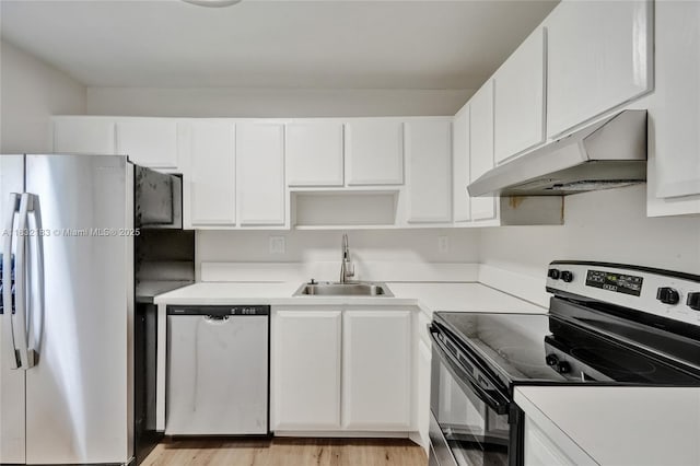 303 Gardens Dr Unit 203, Pompano Beach, FL 33069 - kitchen featuring appliances with stainless steel finishes, under cabinet range hood, white cabinetry, light countertops, and light wood-style floors