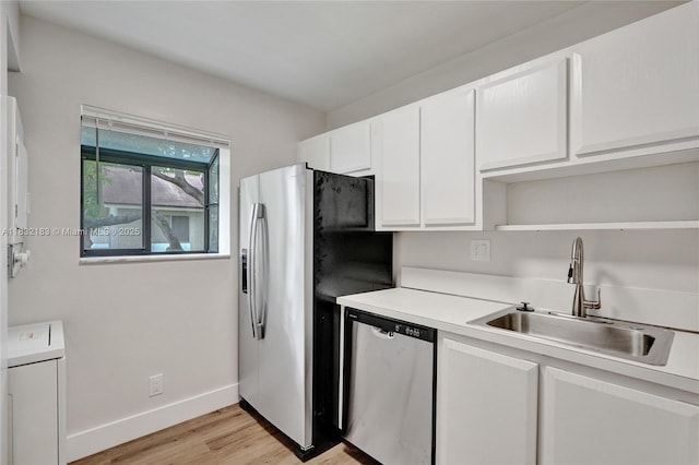 303 Gardens Dr Unit 203, Pompano Beach, FL 33069 - kitchen featuring stainless steel appliances, light wood-type flooring, open shelves, white cabinetry, and light countertops
