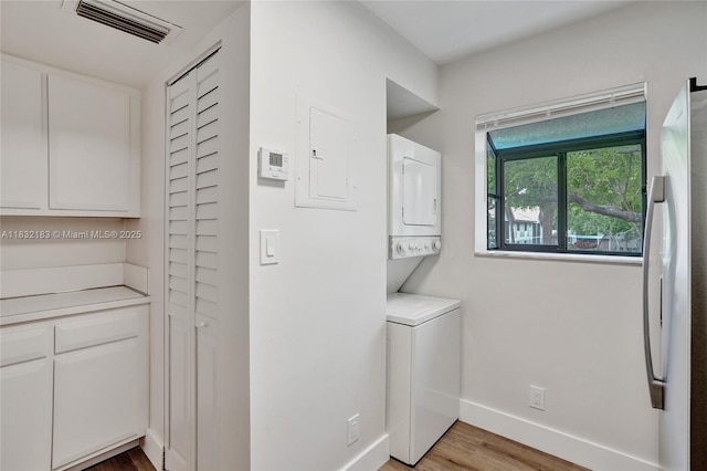 303 Gardens Dr Unit 203, Pompano Beach, FL 33069 - laundry room featuring stacked washer / dryer and light wood finished floors