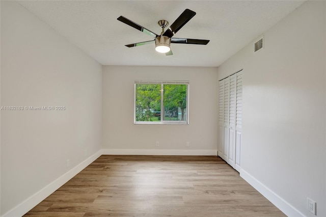 303 Gardens Dr Unit 203, Pompano Beach, FL 33069 - unfurnished bedroom featuring wood finished floors and ceiling fan