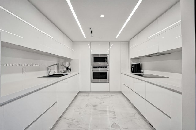 2 Grove Isle Dr Unit B410, Miami, FL 33133 - kitchen featuring appliances with stainless steel finishes, modern cabinets, light marble finish floors, white cabinets, and recessed lighting