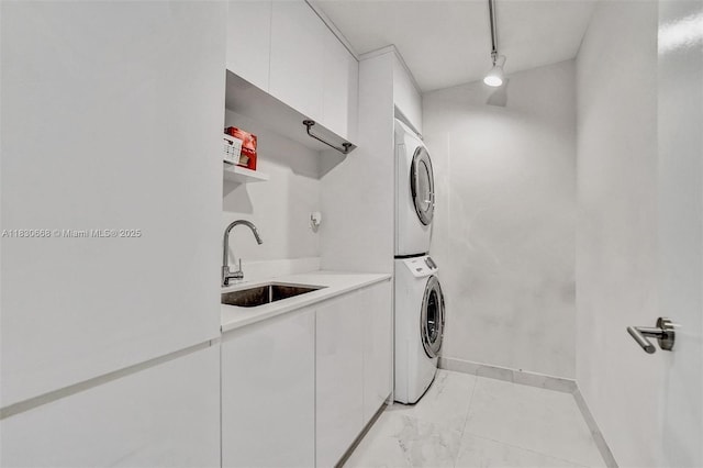 2 Grove Isle Dr Unit B410, Miami, FL 33133 - laundry room featuring stacked washing machine and dryer, cabinet space, and light marble finish floors