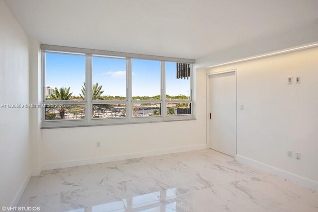 2 Grove Isle Dr Unit B410, Miami, FL 33133 - empty room with marble finish floors