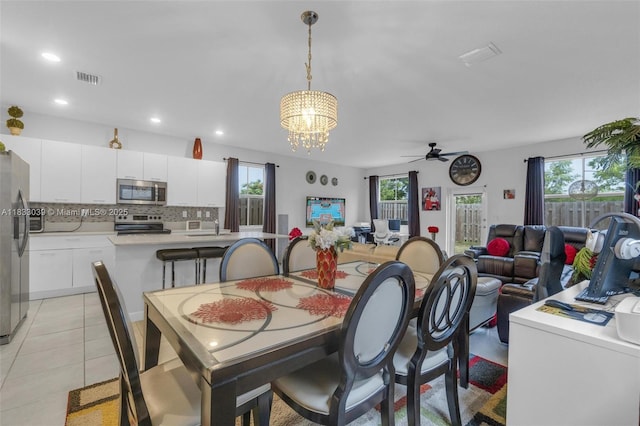 2409 NW 131st Cir, Miami, FL 33167 - dining space featuring ceiling fan, plenty of natural light, a chandelier, light tile patterned floors, and recessed lighting