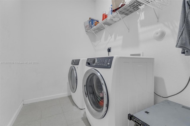 2409 NW 131st Cir, Miami, FL 33167 - laundry room with washer and clothes dryer and light tile patterned floors