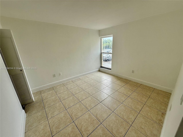 11925 NE 2nd Ave Unit B207, North Miami, FL 33161 - spare room featuring light tile patterned floors and baseboards
