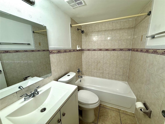 11925 NE 2nd Ave Unit B207, North Miami, FL 33161 - bathroom featuring tile walls, shower / tub combination, vanity, tile patterned flooring, and a wainscoted wall