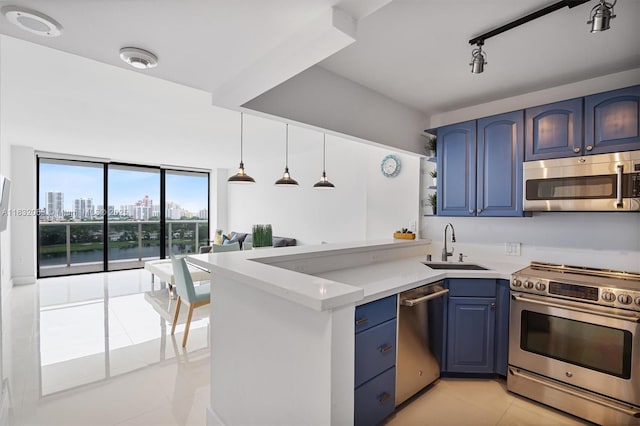 3675 N Country Club Dr Unit 1705, Aventura, FL 33180 - kitchen featuring appliances with stainless steel finishes, blue cabinetry, a peninsula, light tile patterned floors, and light countertops