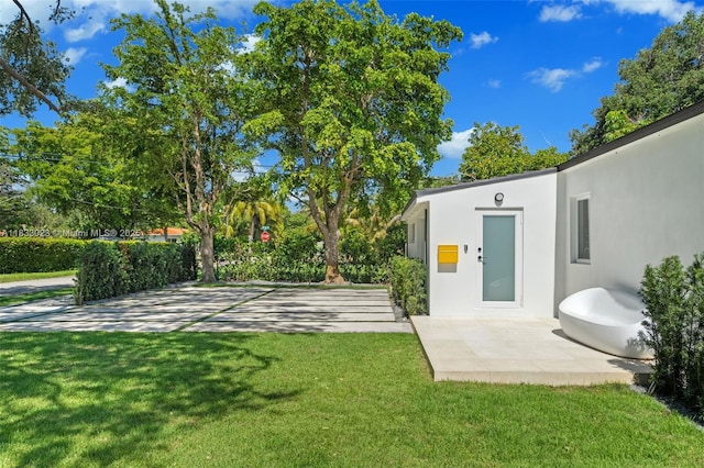 1003 NE 115th St, Biscayne Park, FL 33161 - view of grassy yard featuring a patio area
