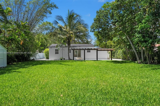 1003 NE 115th St, Biscayne Park, FL 33161 - view of yard with a storage shed