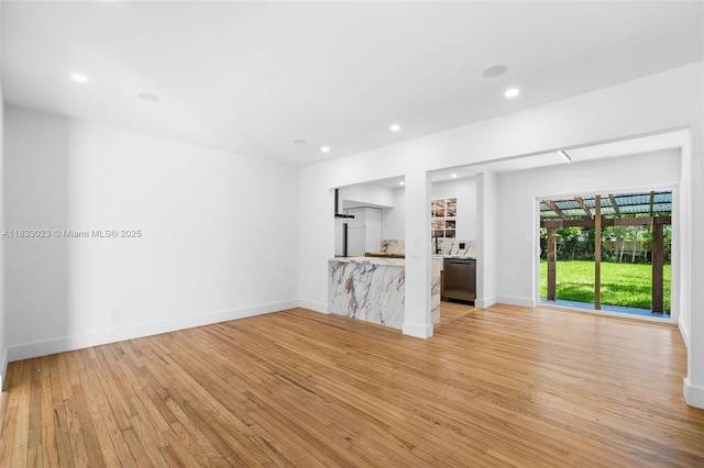 1003 NE 115th St, Biscayne Park, FL 33161 - unfurnished living room featuring light wood finished floors and recessed lighting