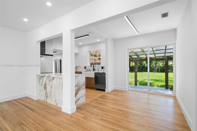1003 NE 115th St, Biscayne Park, FL 33161 - kitchen with black dishwasher, light wood finished floors, light countertops, healthy amount of natural light, and recessed lighting