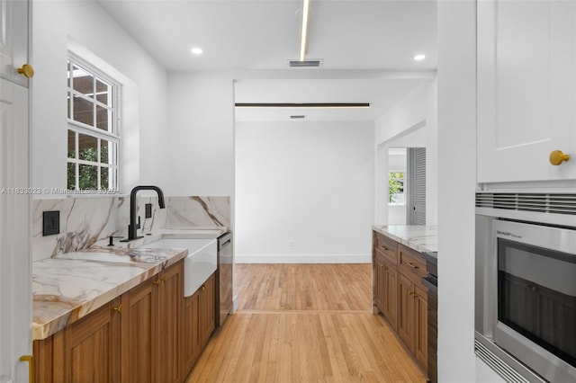 1003 NE 115th St, Biscayne Park, FL 33161 - laundry room with healthy amount of natural light, light wood finished floors, and recessed lighting