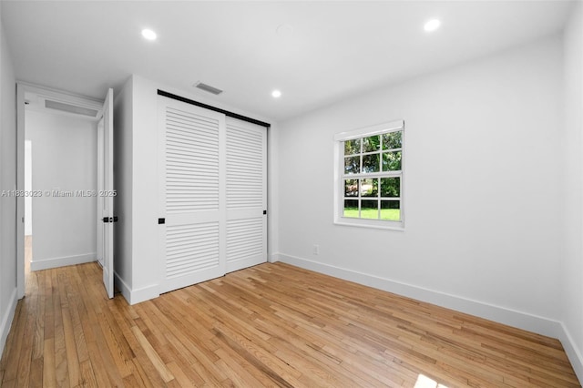 1003 NE 115th St, Biscayne Park, FL 33161 - unfurnished bedroom featuring light wood-style floors, a closet, and recessed lighting