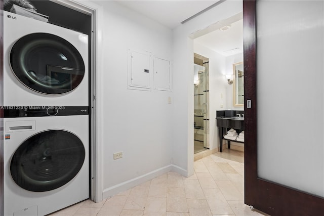 4391 Collins Ave Unit 623, Miami Beach, FL 33140 - laundry area with stacked washer / dryer, electric panel, and light tile patterned flooring