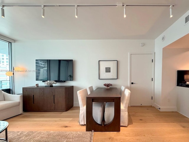 1331 Brickell Bay Dr Unit 506, Miami, FL 33131 - dining space featuring track lighting and light wood finished floors