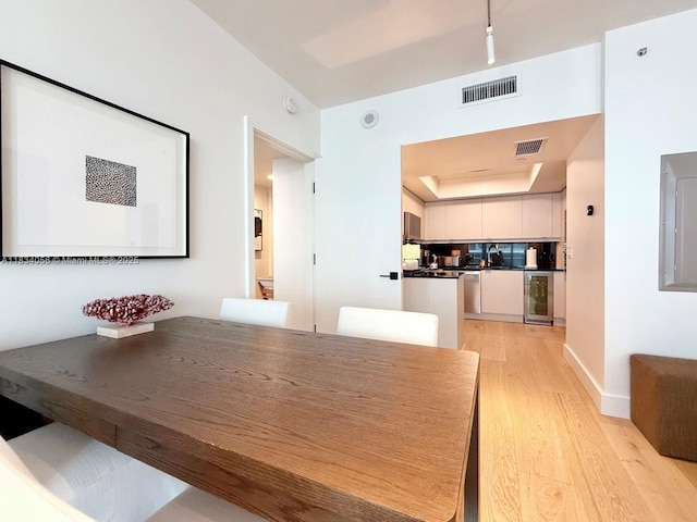 1331 Brickell Bay Dr Unit 506, Miami, FL 33131 - dining room featuring wine cooler, light wood-style flooring, and electric panel