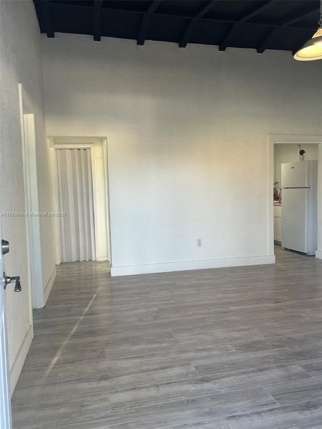 22020 SW 115th Ct, Miami, FL 33170 - spare room featuring beamed ceiling, wood finished floors, and a towering ceiling