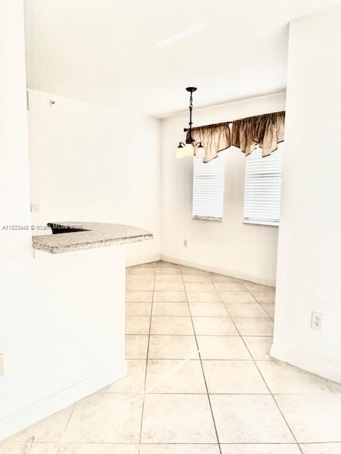 9021 SW 94th St Unit 606, Miami, FL 33176 - spare room with light tile patterned floors and a chandelier