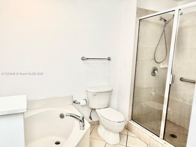 9021 SW 94th St Unit 606, Miami, FL 33176 - bathroom with a bath, a stall shower, and tile patterned flooring
