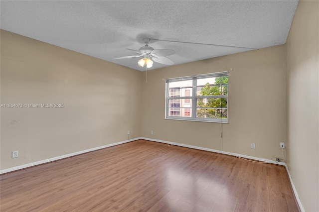 1100 NW 87th Ave Unit 306, Coral Springs, FL 33071 - spare room with a textured ceiling, wood finished floors, and a ceiling fan