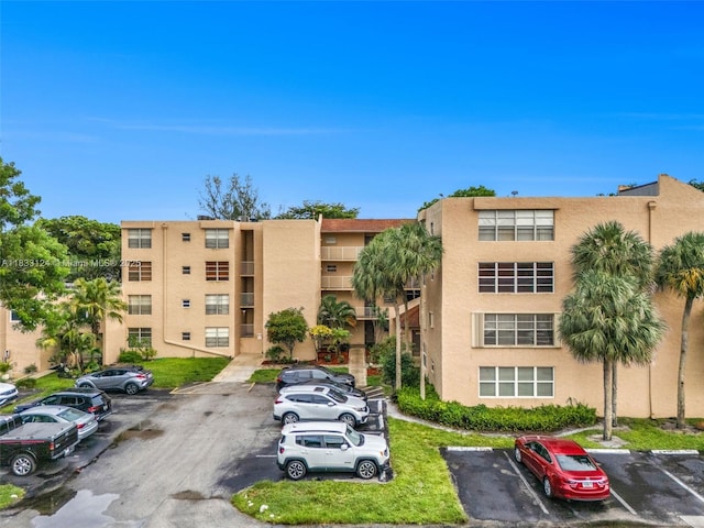 9460 Live Oak Pl Unit 407, Davie, FL 33324 - view of apartment building / complex featuring uncovered parking