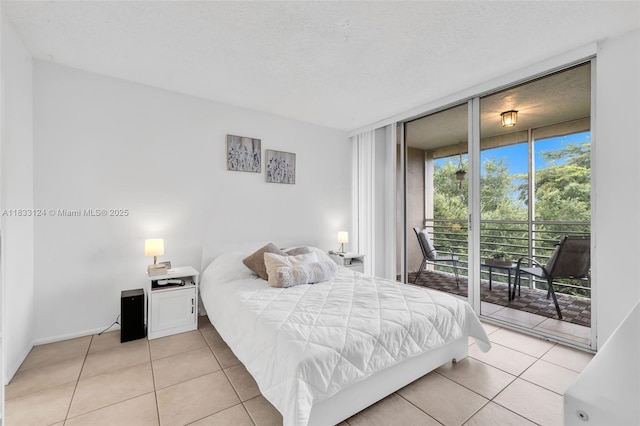 9460 Live Oak Pl Unit 407, Davie, FL 33324 - bedroom featuring access to outside, light tile patterned floors, and expansive windows