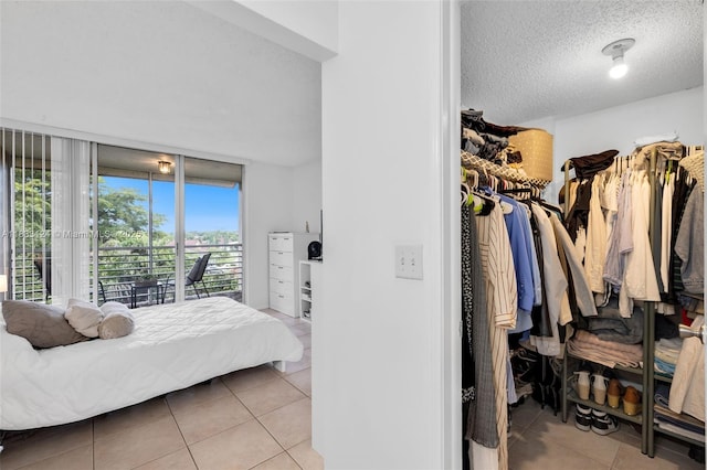 9460 Live Oak Pl Unit 407, Davie, FL 33324 - bedroom with tile patterned flooring, access to exterior, and a textured ceiling