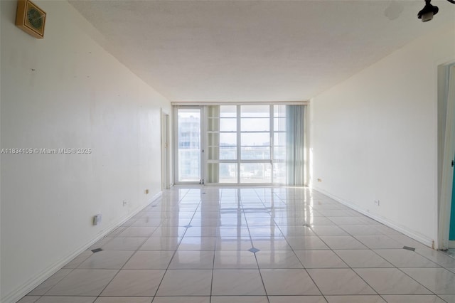 230 174th St Unit 2207, Sunny Isles Beach, FL 33160 - empty room with floor to ceiling windows and light tile patterned floors
