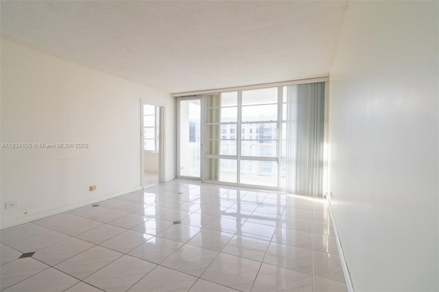 230 174th St Unit 2207, Sunny Isles Beach, FL 33160 - empty room featuring expansive windows and light tile patterned floors