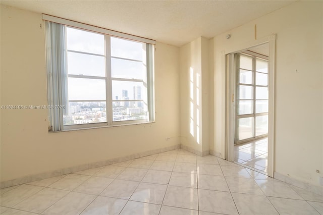 230 174th St Unit 2207, Sunny Isles Beach, FL 33160 - unfurnished room featuring light tile patterned floors and a textured ceiling
