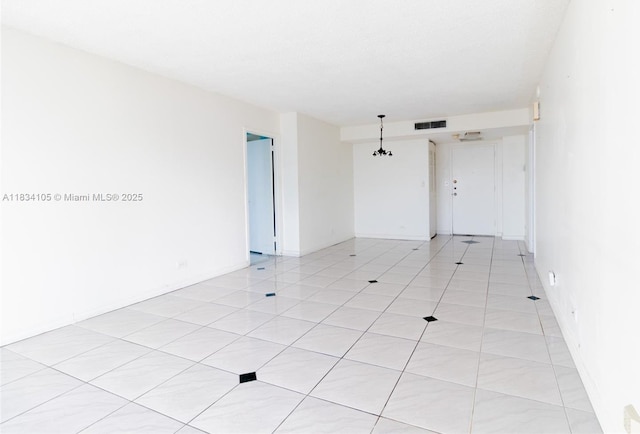 230 174th St Unit 2207, Sunny Isles Beach, FL 33160 - spare room featuring light tile patterned floors and a chandelier