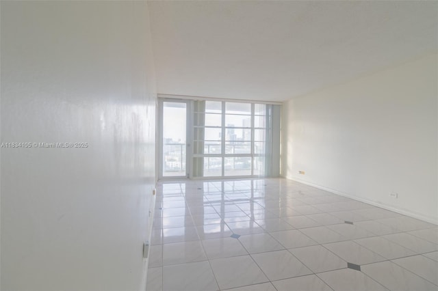 230 174th St Unit 2207, Sunny Isles Beach, FL 33160 - unfurnished room featuring a wall of windows and baseboards