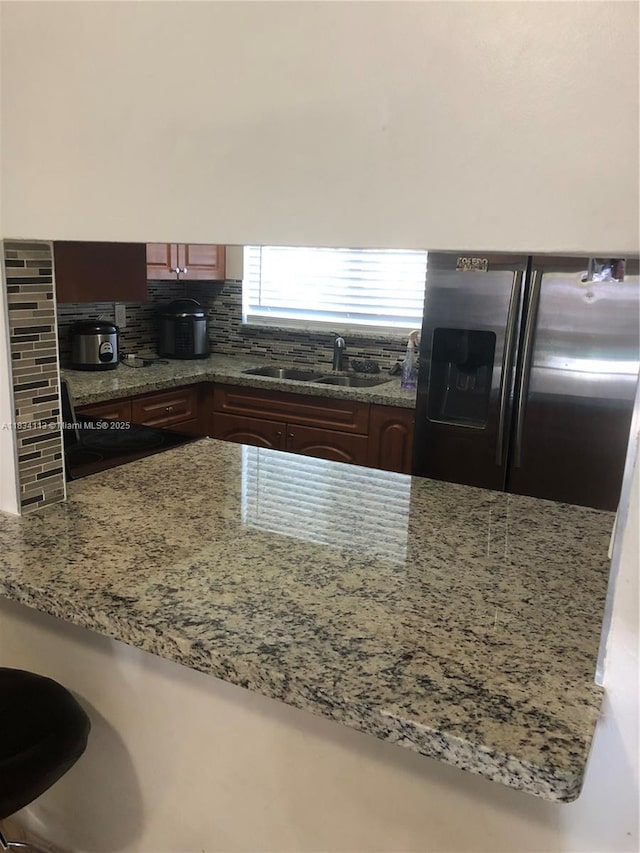 16700 NW 55th Ave Unit 12, Miami Gardens, FL 33055 - kitchen featuring stainless steel fridge, light stone countertops, and tasteful backsplash