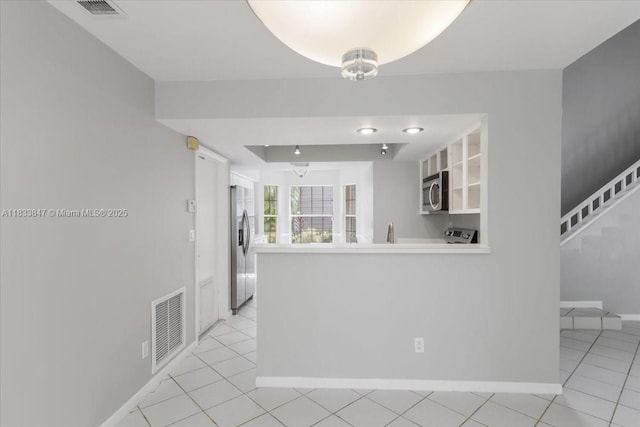 5366 214th Ct S, Boca Raton, FL 33486 - kitchen with stainless steel appliances, a peninsula, light tile patterned flooring, and light countertops