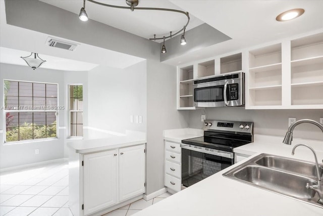 5366 214th Ct S, Boca Raton, FL 33486 - kitchen featuring stainless steel appliances, open shelves, light countertops, a peninsula, and light tile patterned flooring