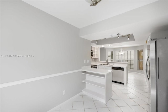 5366 214th Ct S, Boca Raton, FL 33486 - kitchen with stainless steel appliances, a peninsula, light countertops, light tile patterned flooring, and glass insert cabinets