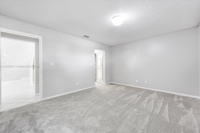 5366 214th Ct S, Boca Raton, FL 33486 - spare room with carpet, a textured ceiling, and tile patterned floors