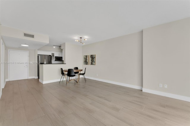 325 S Biscayne Blvd Unit 2816, Miami, FL 33131 - unfurnished living room featuring light wood-style floors